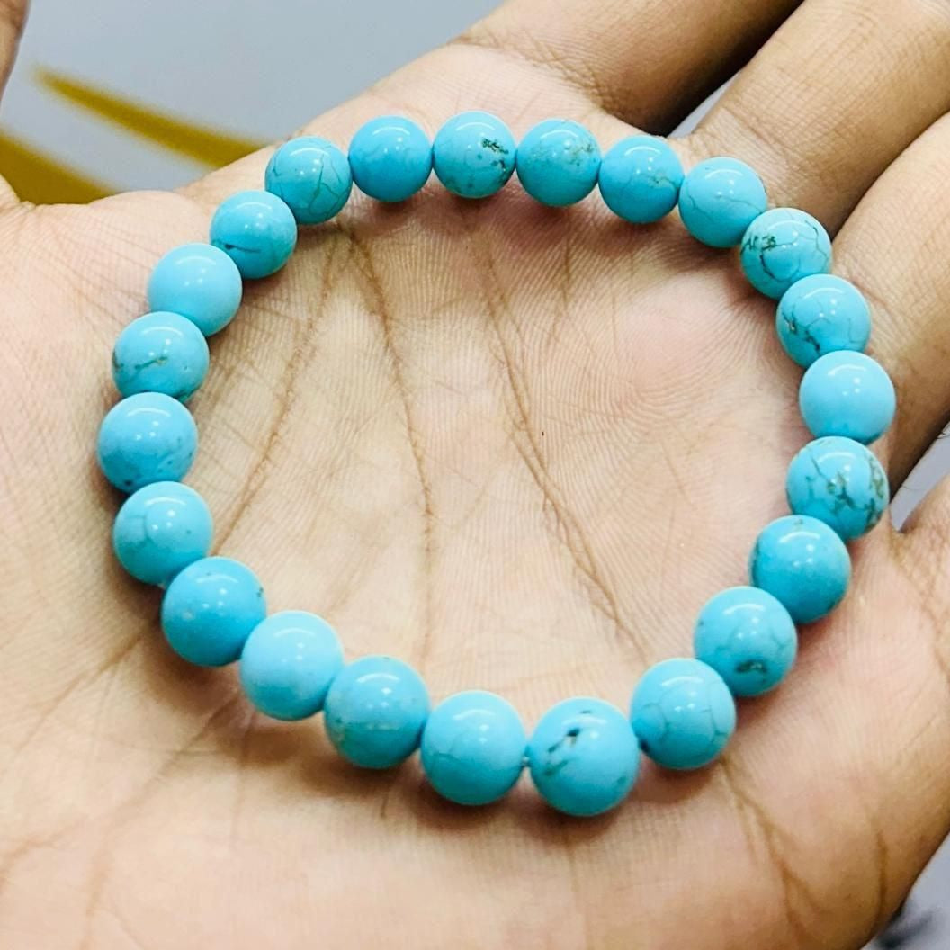 Turquoise beaded bracelet on a hand